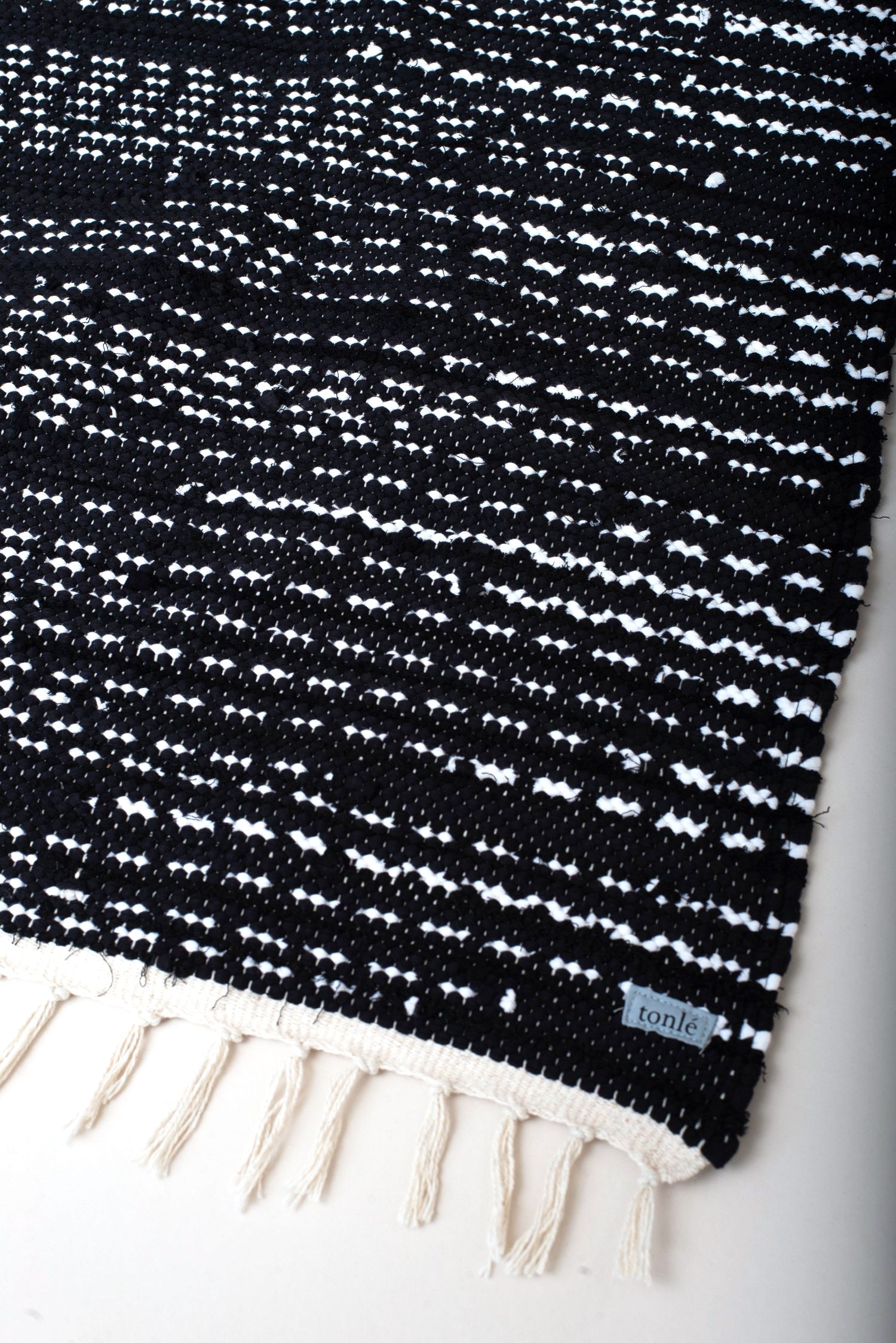 nimol handwoven rug with ties - black and white tones