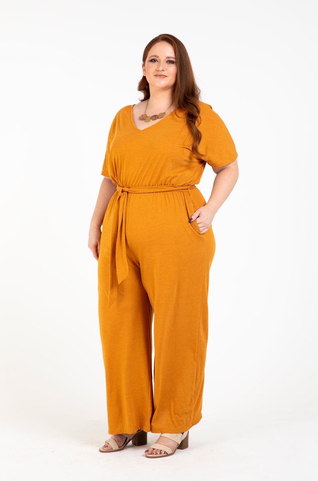 Front view of the zero waste tola jumpsuit in mango reclaimed jersey. Liesje is wearing size L