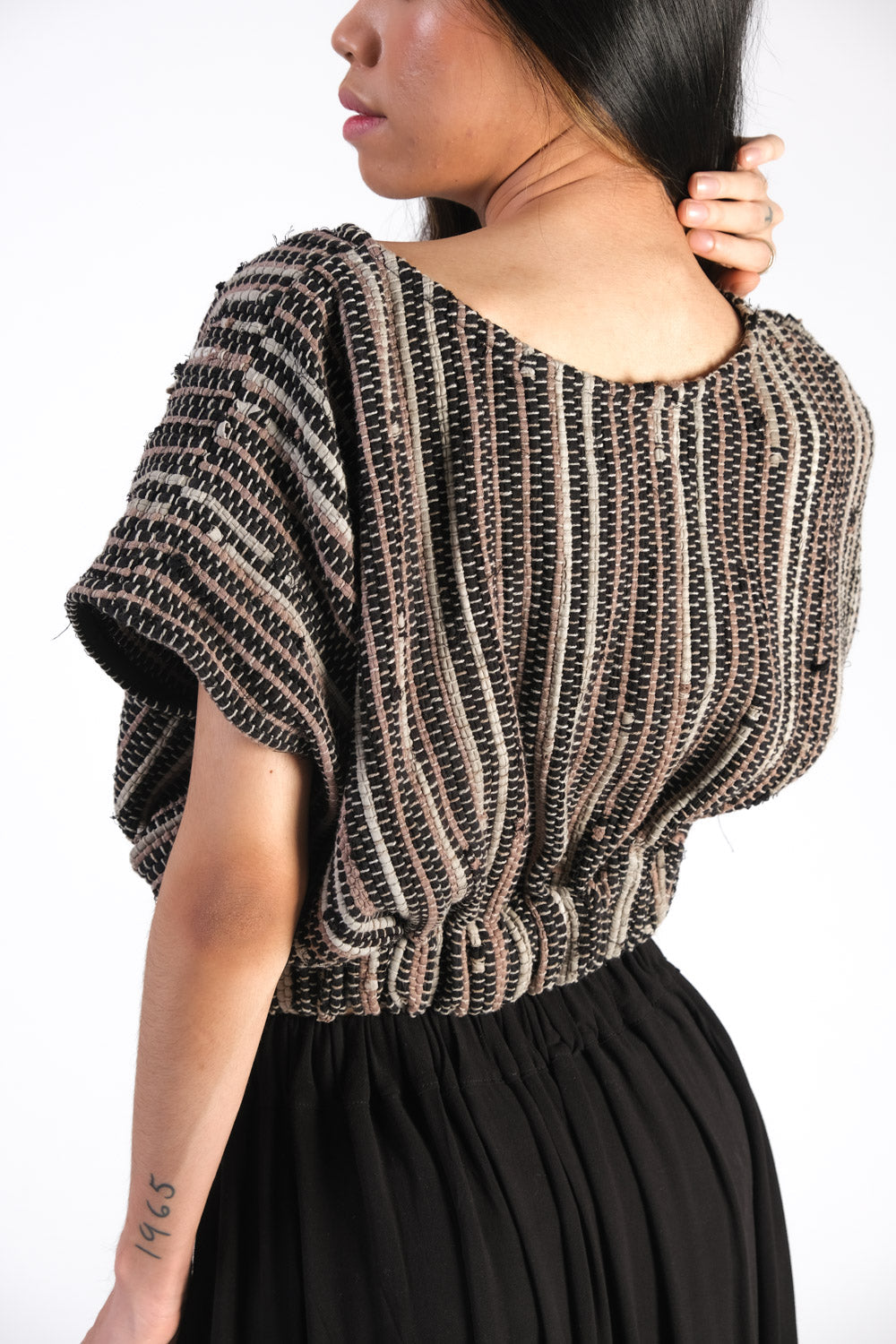 Back detail of the handwoven srey cinched top in onyx with boat neck and slight open sleeve