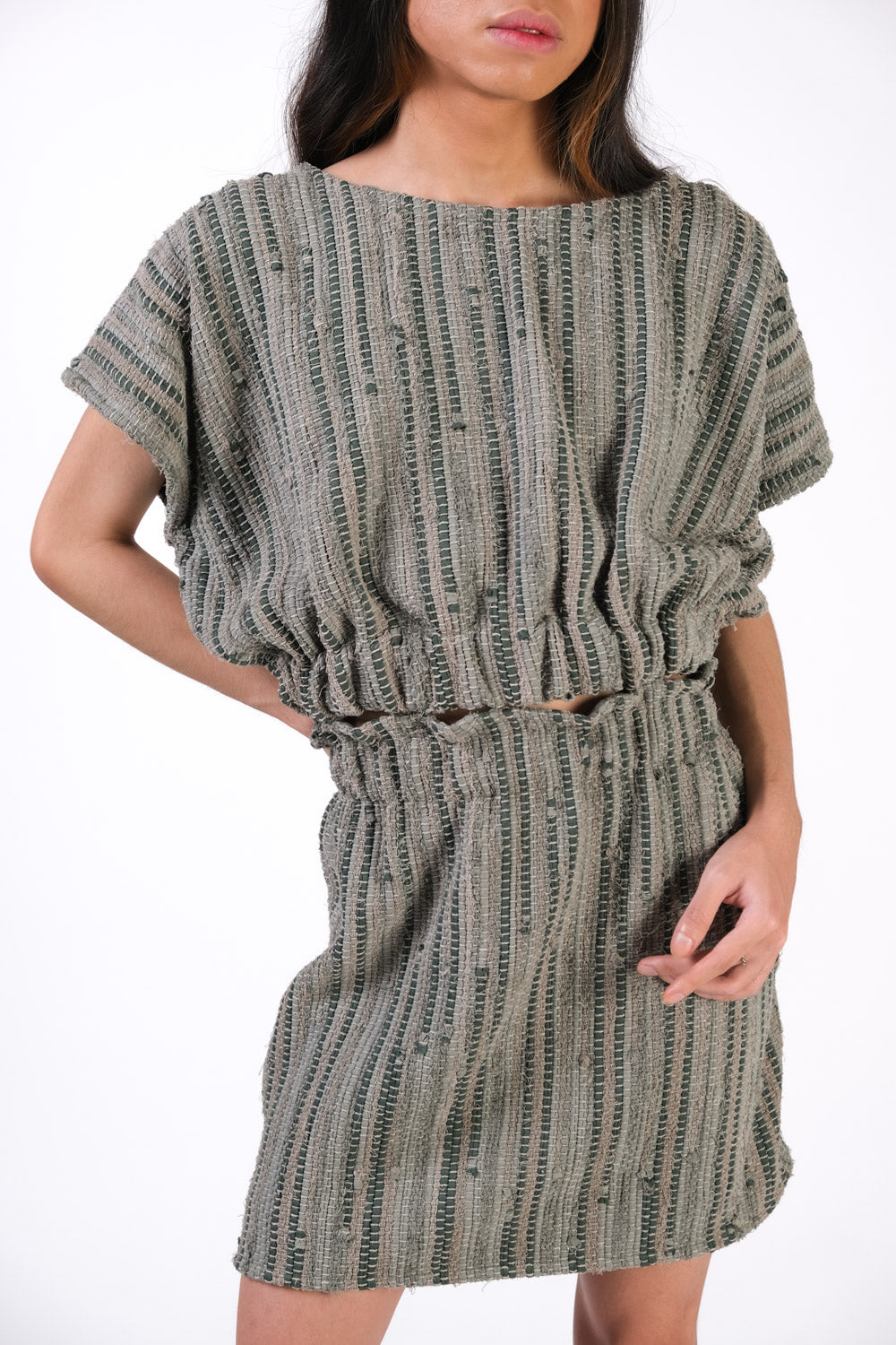Closeup of the handwoven sage cinch top, made using handwoven reclaimed textiles. The cinch top is paired here with the srey handwoven mini skirt with paper bag waist