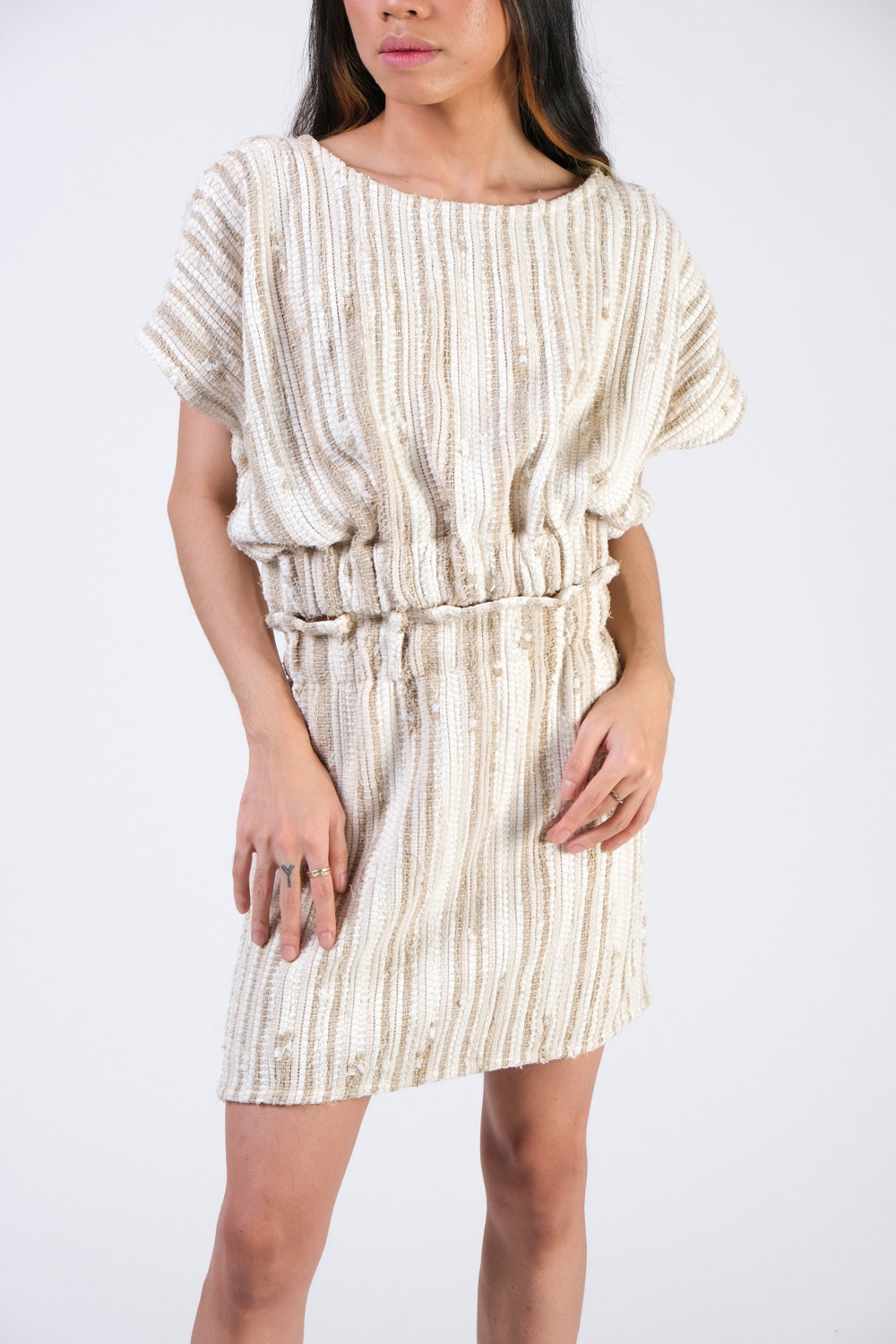 Front closeup of the srey cinch top in cream with coordinating mini skirt, made using upcycled handwoven textiles as part of tonlé's zero waste model