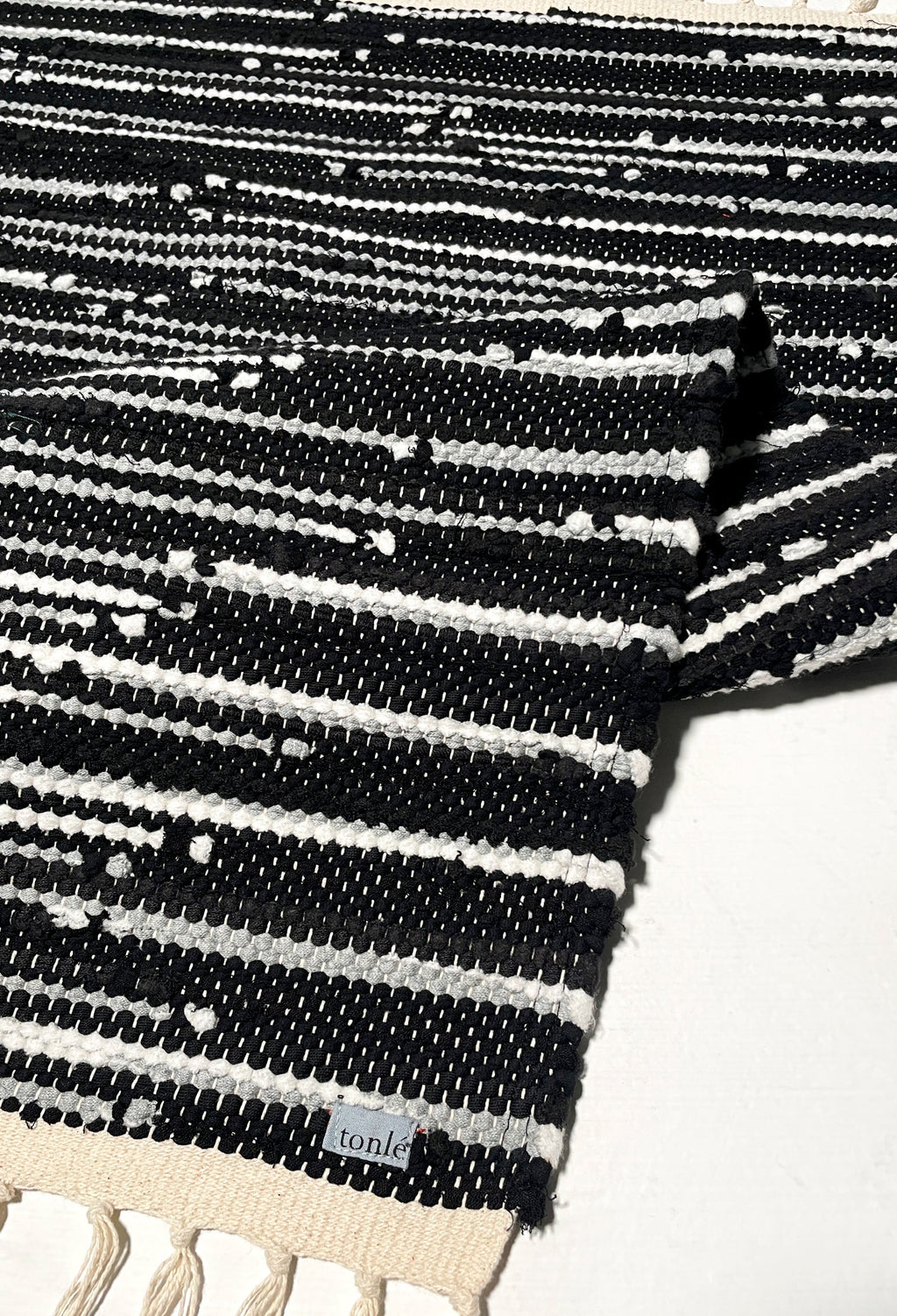 nimol handwoven rug with ties - black and white tones