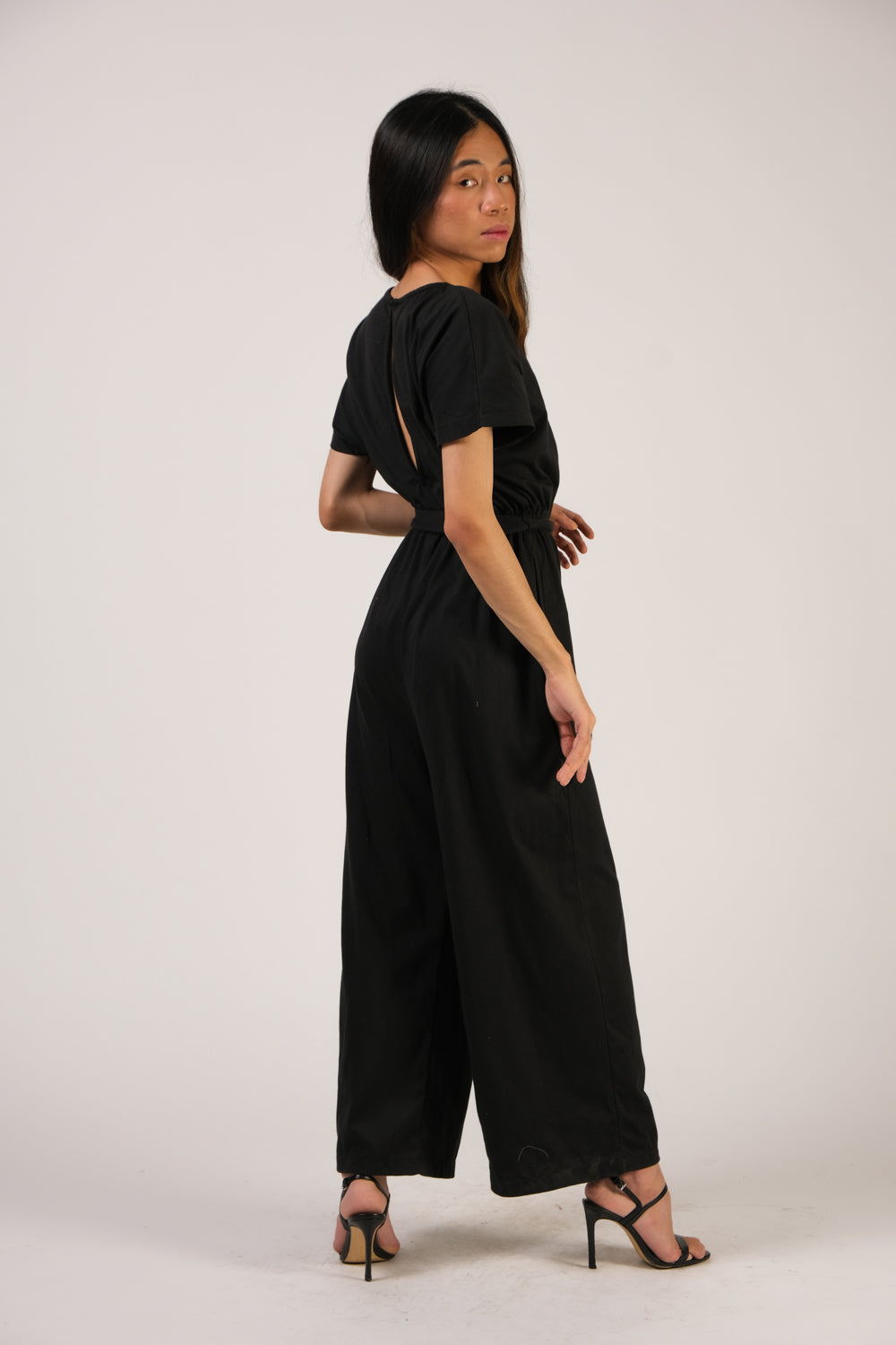 Back view of the the tola jumpsuit in black, part of tonlé's zero waste spring 2022 collection